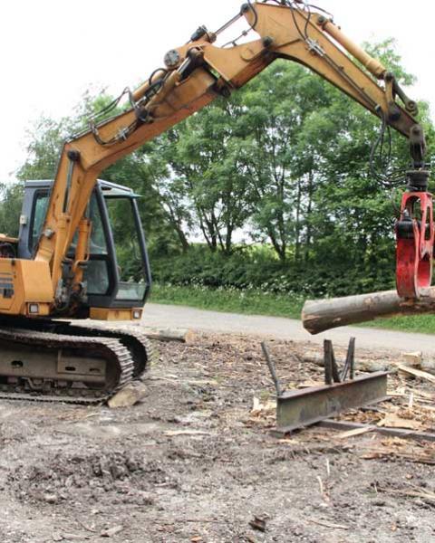 A piece of timber is picked from the stack